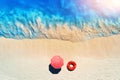 Aerial view of blue sea, sandy beach with red swim ring, umbrella Royalty Free Stock Photo