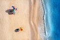 Aerial view of blue sea, waves, sandy beach and umbrellas Royalty Free Stock Photo