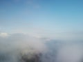 Aerial view. Blue sky sun and fog over calm sea. The drone flies over foggy and fluffy clouds. Abstract aerial nature Royalty Free Stock Photo