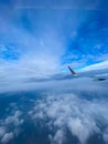 Aerial view of blue sky with white clouds and airplane wing. Royalty Free Stock Photo