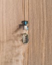 Aerial view of a blue tractor working in a field with a fertilizer and seed spreader