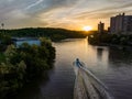 Aerial view of a boat cruising on the Spuyten Duyvil Creek by Inward Hills Park at sunset. NY.