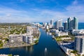 Aerial view of boat on Miami Beach canal with a flock of crows