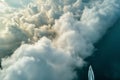 aerial view of boat navigating a pathway through towering cumulus formations