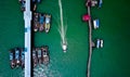 Aerial view of a boat passing by other boats in an asian styled harbour