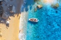 Aerial view of boat, sandy beach, blue sea with waves at sunset Royalty Free Stock Photo