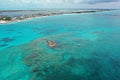 Aerial view of boats anchored off coral rocks with North Bimini in background. Royalty Free Stock Photo