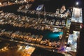 Aerial view of boats and beautiful city at night in Sorrento, Italy. Amazing landscape with boats in marina bay, sea, city lights Royalty Free Stock Photo