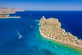 Aerial view of boats in a crystal clear blue ocean next to a small island Royalty Free Stock Photo