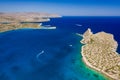 Aerial view of boats in a crystal clear blue ocean next to a small island Royalty Free Stock Photo