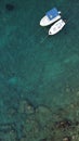 Aerial view of boats in crystal clear blue ocean waters of Corfu Island in Greece. Royalty Free Stock Photo