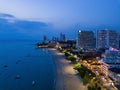 Aerial view of boats in Pattaya sea, beach at night, and urban city with blue sky for travel background. Chon buri Province, Royalty Free Stock Photo