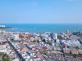 Aerial view of boats in Pattaya sea, beach, and urban city with blue sky for travel background. Chonburi, Thailand