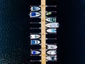 Aerial view of boats, yachts, water bike and wooden sauna in a marina in Finland