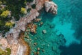 Aerial View of Body of Water Near Cliff, Aerial perspective of a rocky coastline with clear, calm waters, AI Generated Royalty Free Stock Photo