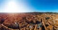 Aerial view of Bologna, Italy at sunset. Colorful sky over the historical city center with car traffic and old buildings roofs. Royalty Free Stock Photo