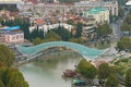 Aerial View of the Bow Shaped Bridge of Peace over Mtkvari or Kura River, Famous Landmark of Tbilisi, Capital City of Georgia