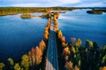 Aerial view of bridge across blue lakes in colorful autumn forest in Finland Royalty Free Stock Photo