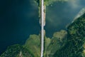 Aerial view of bridge asphalt road with cars and blue water lake and green woods in Finland Royalty Free Stock Photo