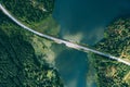 Aerial view of bridge asphalt road with cars and blue water lake and green woods in Finland Royalty Free Stock Photo