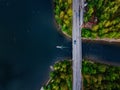 Aerial view of the bridge with a boat passing under it. Blue lake with summer houses in Finland Royalty Free Stock Photo