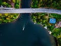 Aerial view of the bridge with a boat passing under it. Blue lake with summer houses in Finland Royalty Free Stock Photo