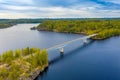 Aerial view of the bridge and island on a blue lake Saimaa. Landscape with drone. Blue lakes, islands and green forests from above Royalty Free Stock Photo