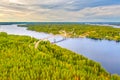 Aerial view on the bridge over the lake in Puumala, and trees in the forest on the shore. Blue lakes, islands and green forests Royalty Free Stock Photo