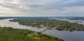 Aerial view on the bridge over the lake and trees in the forest on the shore. Blue lakes, islands and green forests from above on Royalty Free Stock Photo