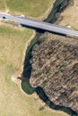 Aerial view of bridge over small river in countryside. spring landscape with road, fields and forest Royalty Free Stock Photo