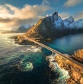 Aerial view of bridge, sea with waves and mountains at sunset Royalty Free Stock Photo