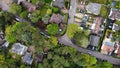 Aerial view of some large detached houses set amongst woodland