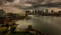 Aerial view of Brooklyn Bridge against skyscrapers of New York on a gloomy day in long exposure