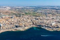 Aerial view of Bugibba town, St. Paul's Bay in the Northern Region, Malta. Popular tourist resort destination with promenade.