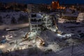 Aerial view of a building demolishing work by excavators in winter night