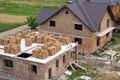 Aerial view of building site in green field. Brick basement floor of future cottage and not finished new big brick house with brow Royalty Free Stock Photo