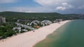 Aerial view of the Bulgarian town of Albena unfolds along the picturesque seaside. Its sandy beaches, stretching as far