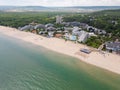 Aerial view of the Bulgarian town of Albena unfolds along the picturesque seaside. Its sandy beaches, stretching as far