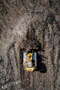 Aerial view of a bulldozer moving waste on a landfill site Royalty Free Stock Photo