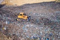 Aerial view on bulldozer working on the landfill.