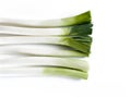 Aerial view of a bunch of leeks on a white table Royalty Free Stock Photo