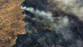 Aerial Drone View burning dry grass. Open flames of fire and smoke. Yellow Dry