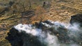 Aerial Drone View burning dry grass. Open flames of fire and smoke. Yellow Dry