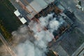 Aerial view of burning industrial building, fire with huge smoke from burned roof Royalty Free Stock Photo