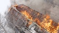 Aerial view the burning roof of the building in winter.