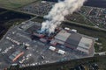 Aerial view of burnt industrial warehouse or logistics center building after big fire with huge smoke from burned roof, drone shot Royalty Free Stock Photo