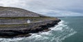 Aerial view of the Burren Coast in County Clare with the Black Head Lighthouse on the rocky point