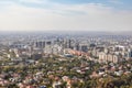 Aerial view of the business center of the city of Almaty surrounded by summer greenery