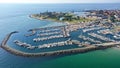 Aerial view of a bustling marina with several boats in the water near the Kronborg Castle