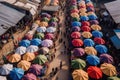 aerial view of a bustling outdoor market with colorful tents